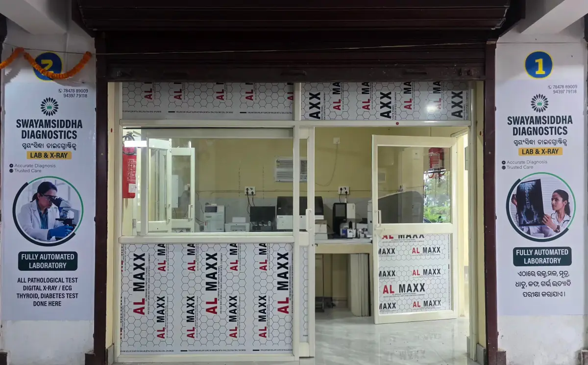 The laboratory seen through its glass front, analysers lined up on the bench